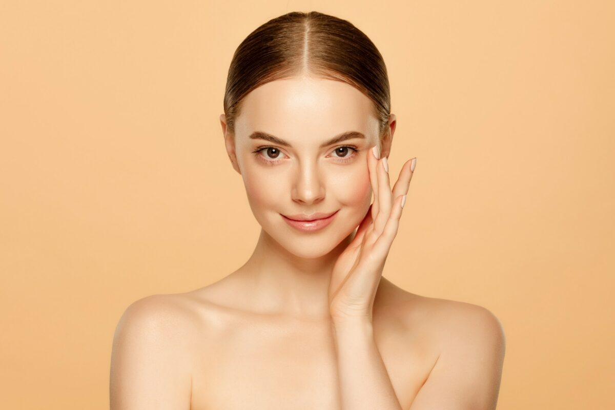 Woman with healthy, glowing skin representing a personalized skincare treatment plan for long-term skin health and facial rejuvenation.