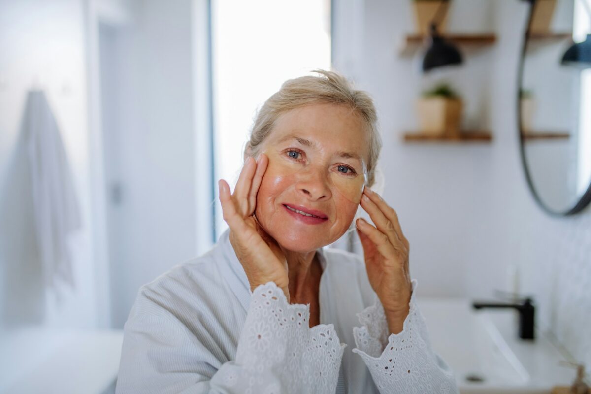 Woman examining smoother skin after Dysport treatment for facial rejuvenation and wrinkle reduction.