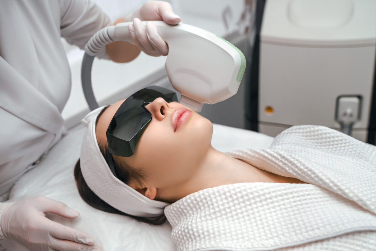 Patient receiving laser skin treatment from a qualified cosmetic laser surgeon using advanced cosmetic laser technology.