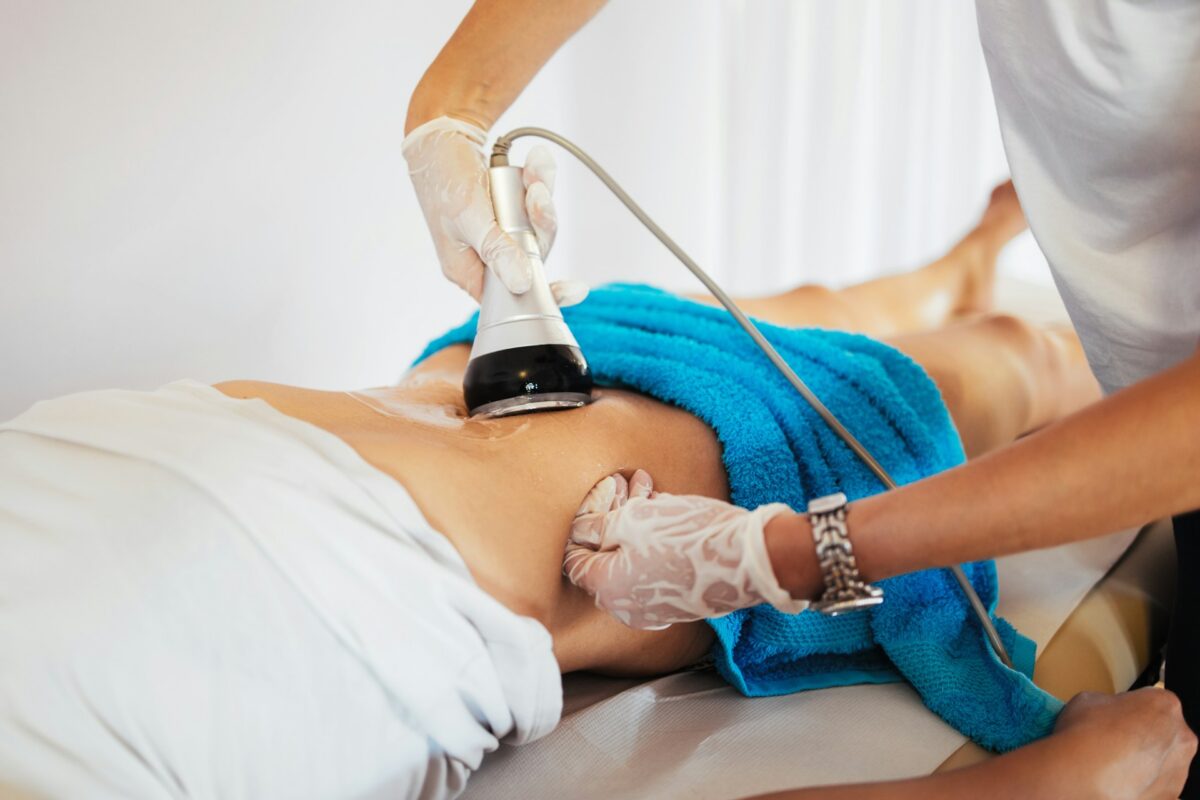 Patient receiving a liposuction body contouring treatment during a cosmetic procedure.