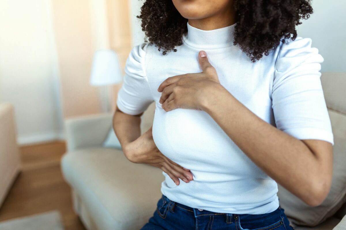 Woman following post cosmetic breast surgery care instructions during breast surgery recovery to support proper healing and comfort.
