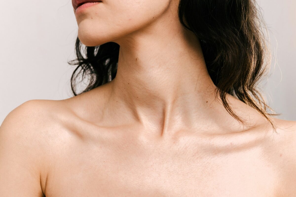 Close-up of a woman's neckline before consulting with a breast reduction surgeon about breast reduction surgery.