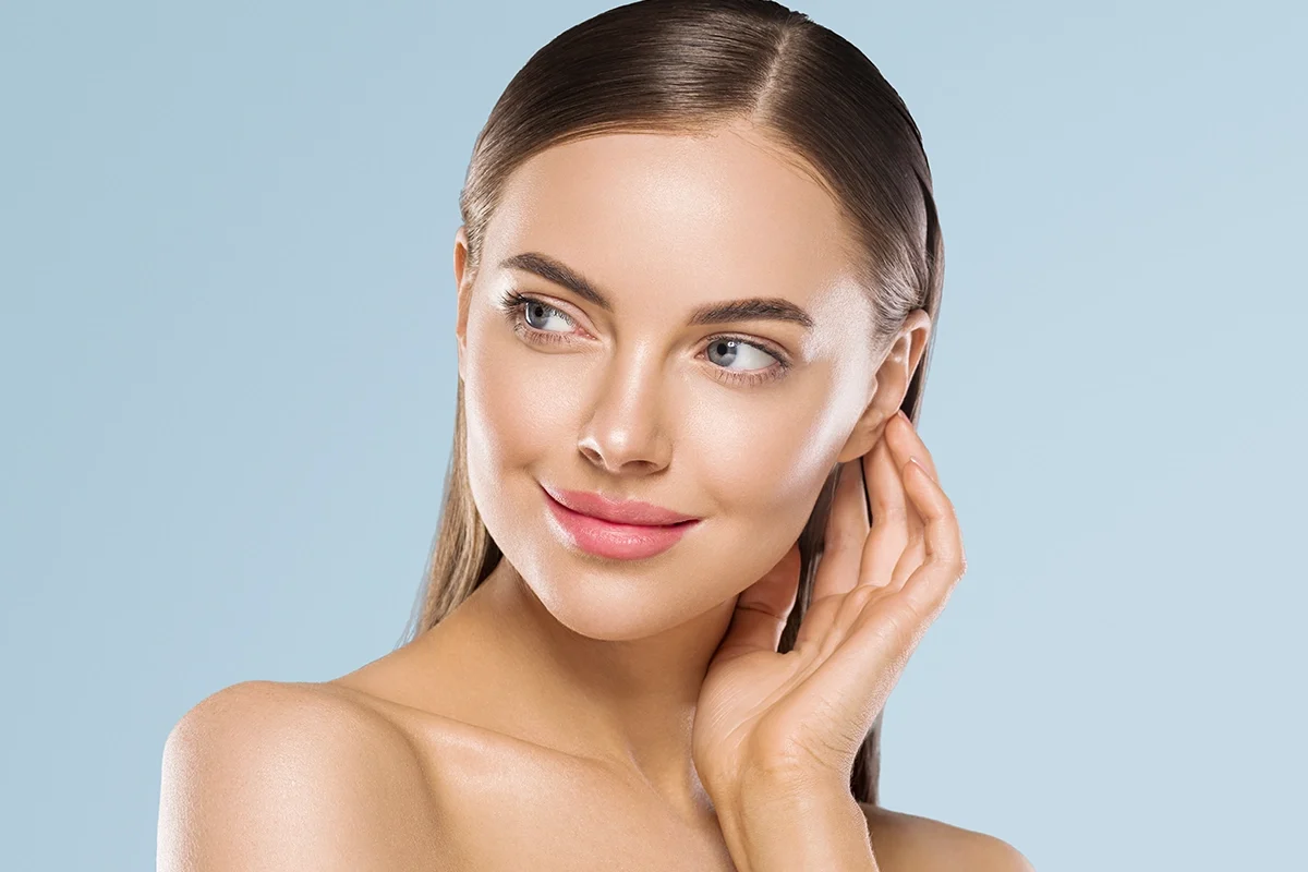 Woman with radiant, youthful skin after collagen restoration with Sculptra to improve facial volume and skin texture.