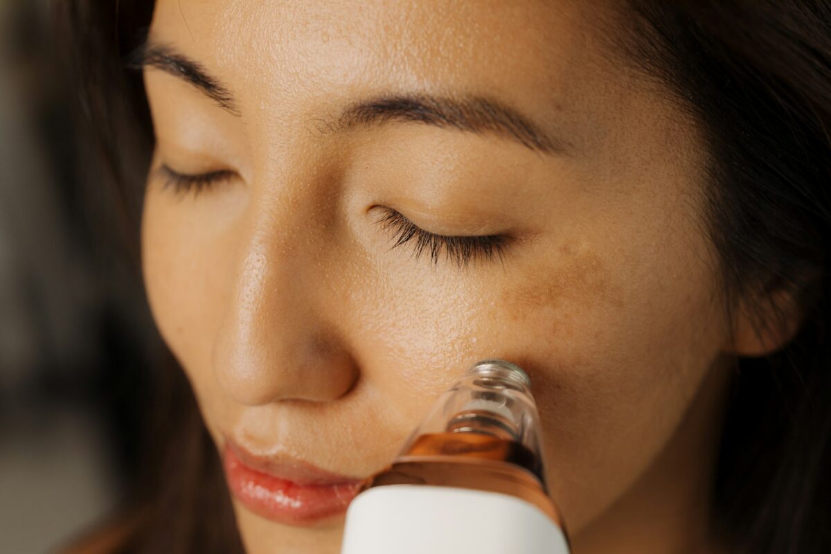 Person receiving a professional microneedling treatment to improve skin texture, acne scars, and overall skin rejuvenation.