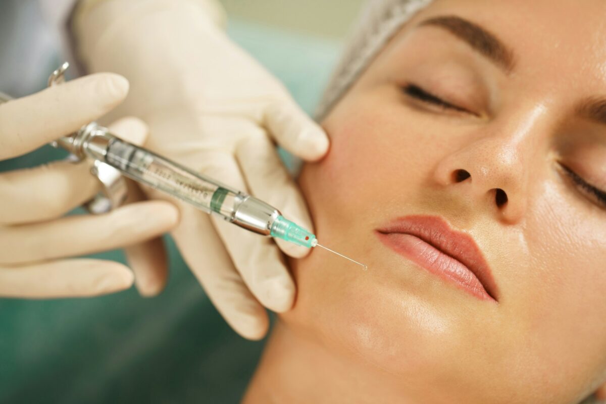 Provider administering a Sculptra injectable treatment to restore facial volume through collagen stimulation.