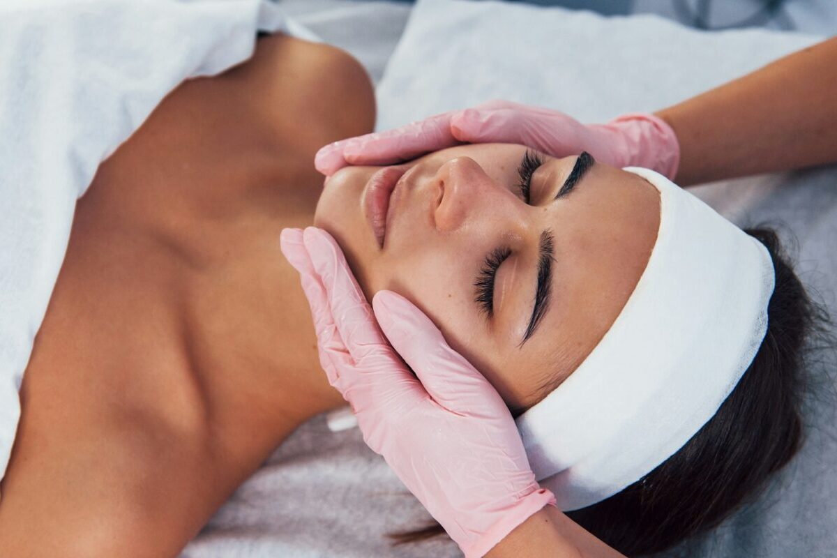 Patient receiving a chemical peel consultation before facial skin rejuvenation treatment.