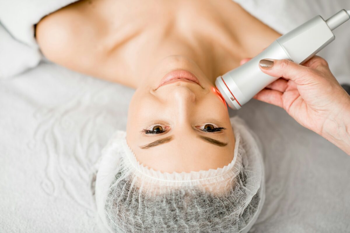 Patient receiving a laser treatment on the face before winter for skin rejuvenation and improved skin texture.