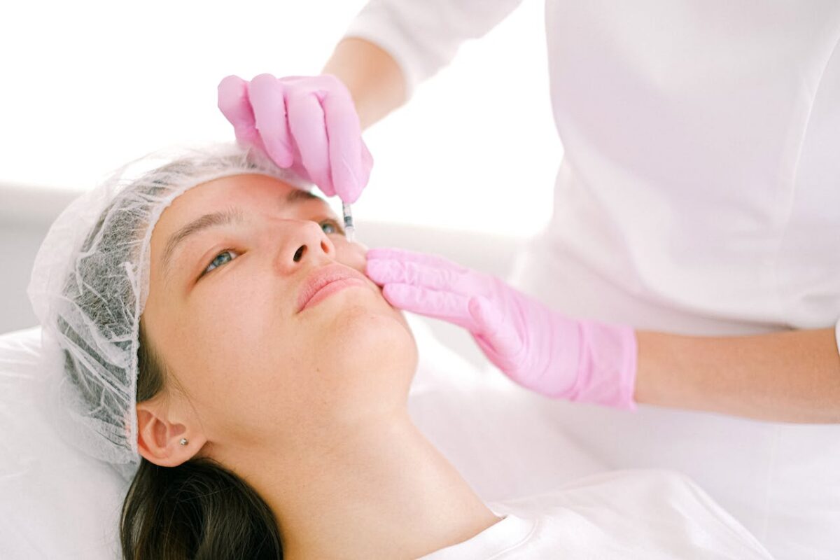 Patient receiving a facial consultation before skin tightening surgery to improve loose skin and facial contours.