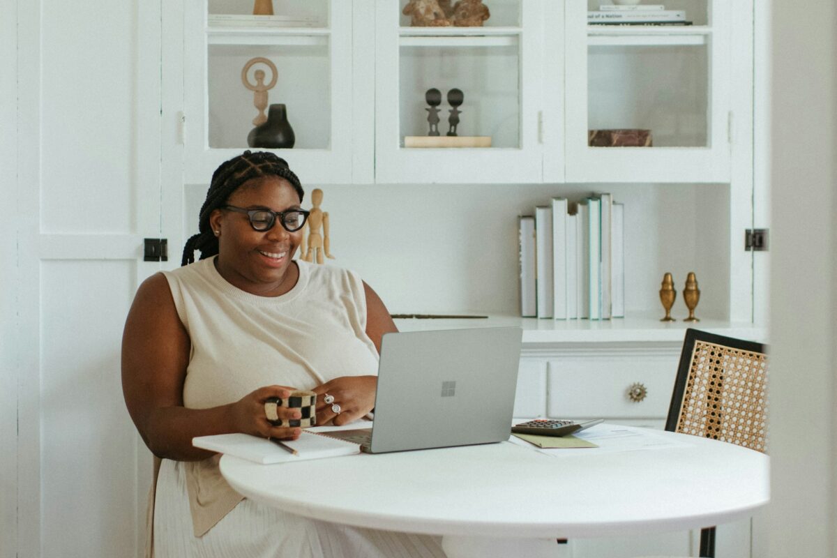 Woman participating in a virtual consultation about breast revision surgery from her home office.