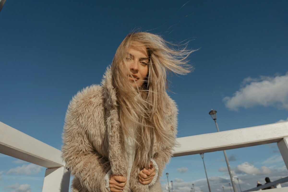 Woman wearing a cozy jacket outdoors while preparing for a breast lift and recovery.