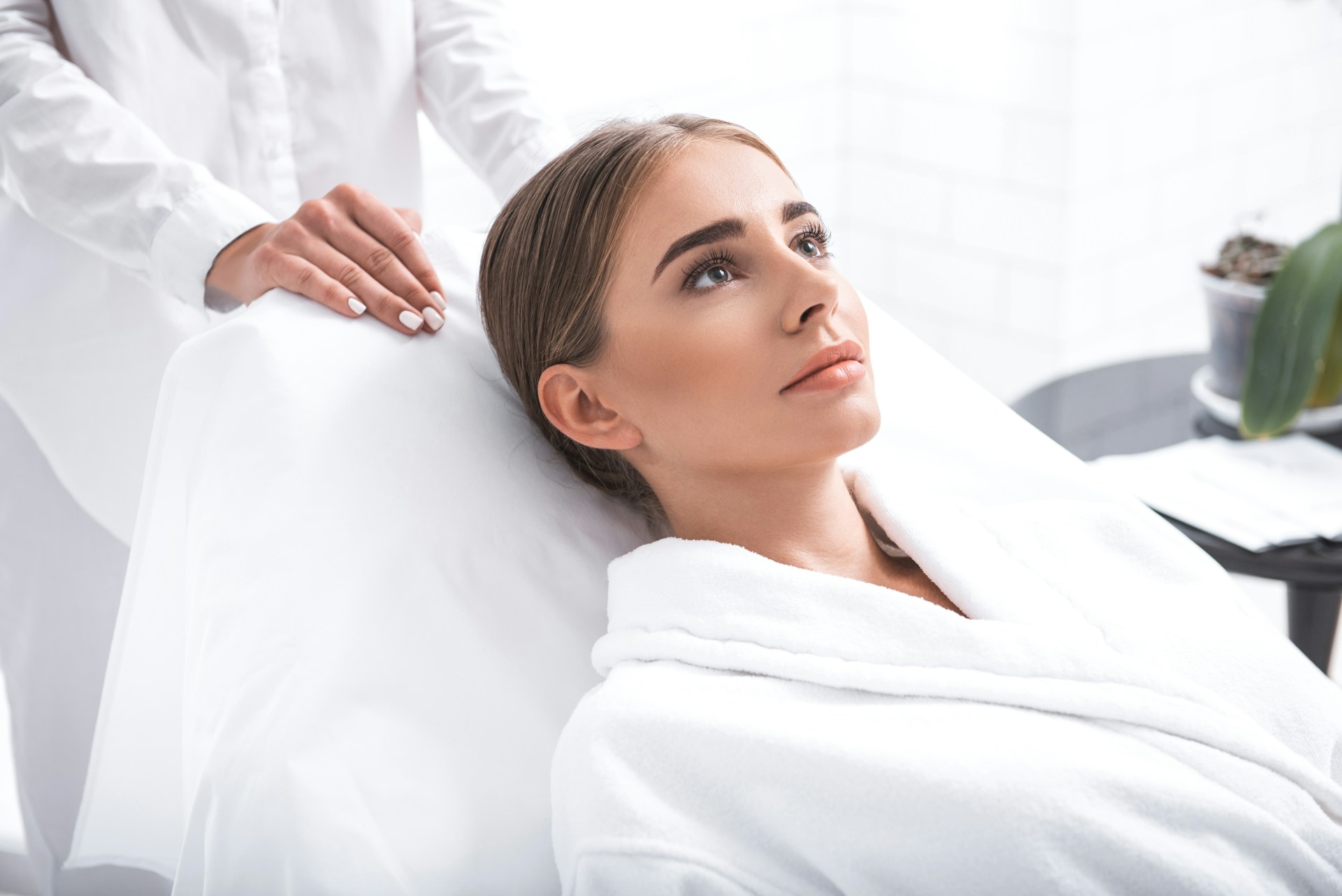 Woman in a consultation room preparing for a personalized mommy makeover treatment plan.