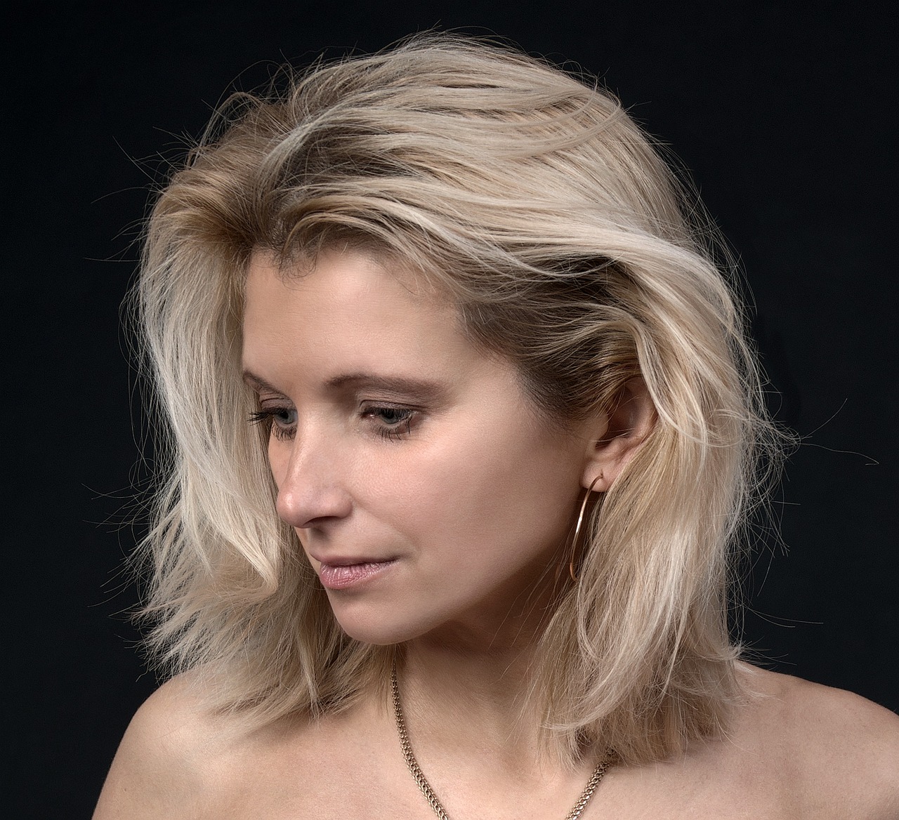 Woman with a refreshed, natural-looking profile representing subtle facial volume support from a Sculptra injector.