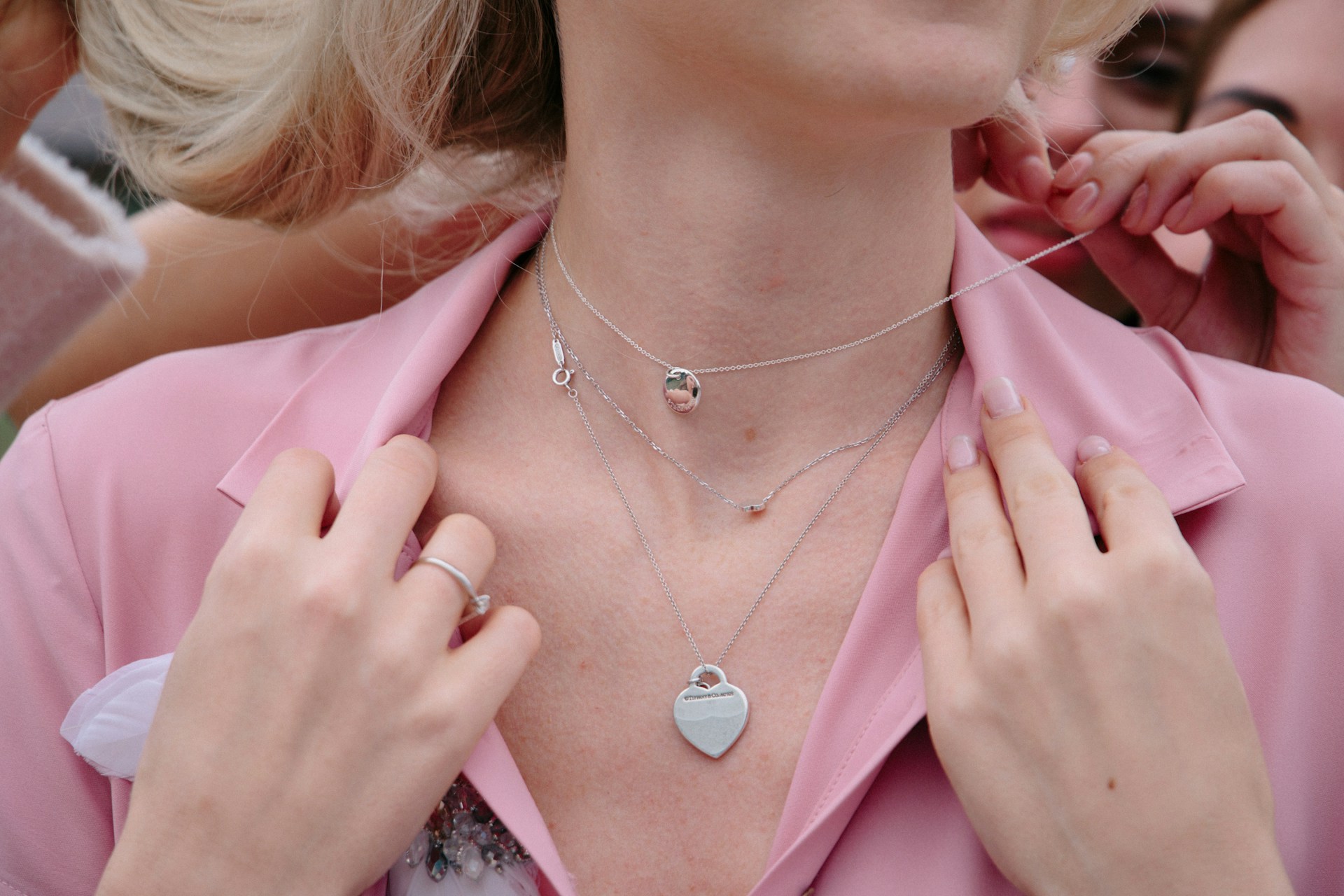 Woman touching her neck while considering skin tightening surgery for loose neck skin and a smoother profile.