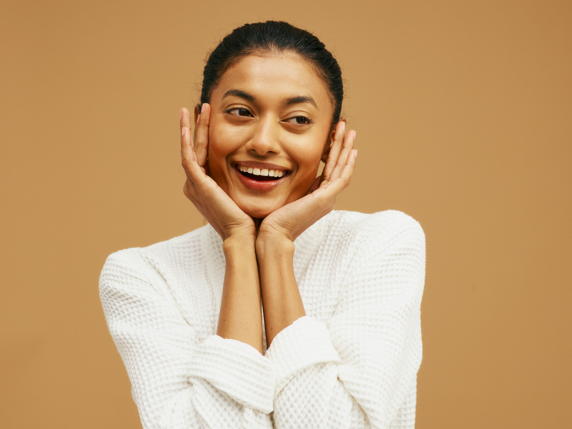 Woman smiling with refreshed-looking skin while considering Daxxify for wrinkles and frown line treatment.